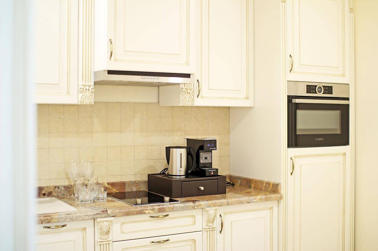 Orion Hotel Bishkek Bagian luar foto A coffee machine in a kitchen