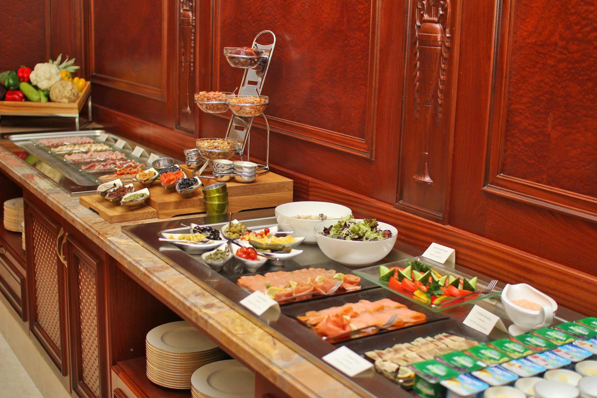 Orion Hotel Bishkek Bagian luar foto A buffet at a hotel
